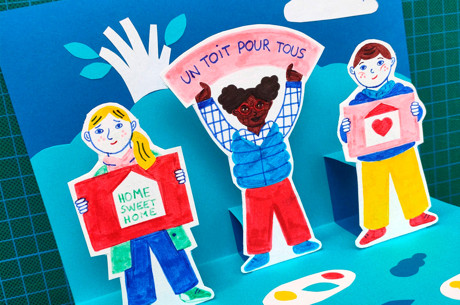 atelier créatif de carte pop-up pour les enfants avec du papier découpé et des feutres en lien avec le roman jeunesse Un toit pour tous